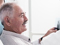 Smiling older man in dental chair