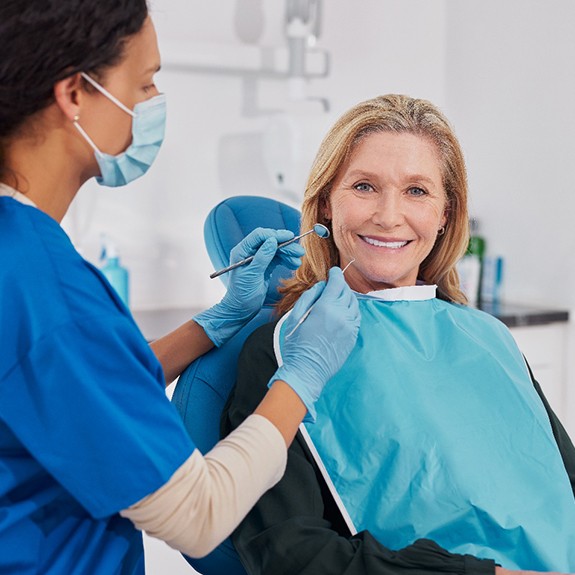 A woman smiling at the dentist