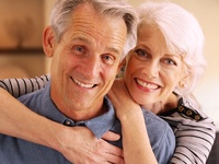 An older man and woman smiling and happy