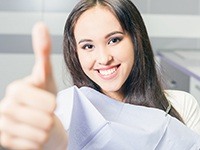 Smiling woman giving thumbs up