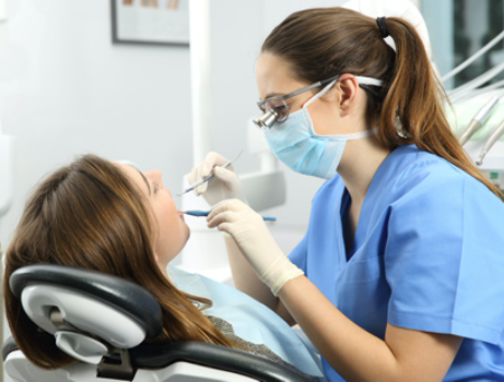 A female patient having her teeth checked at the dentist’s office
