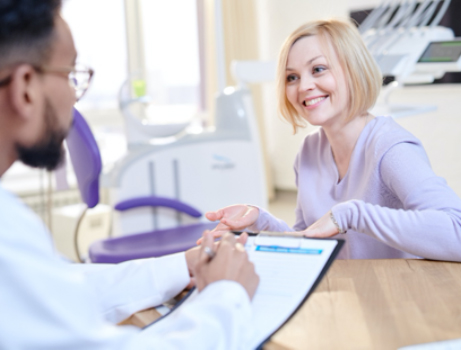 A young woman talking with her dental professional