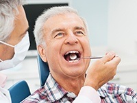 Older man receiving dental exam