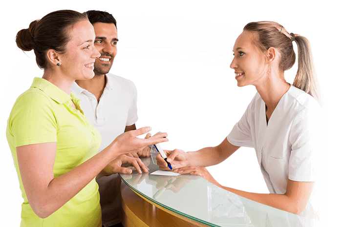 Man and woman talking to dental team member