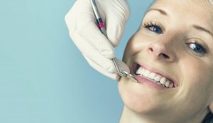 woman smiling sitting in dentist chair