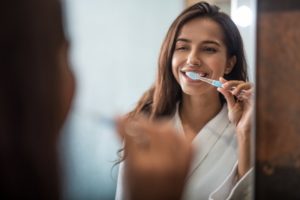 person brushing their teeth while self-quarantining