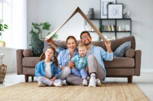 Happy family of four staying inside their home together