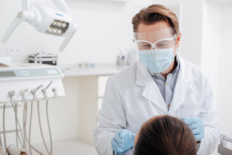 Dentist in Midlothian wearing a face shield