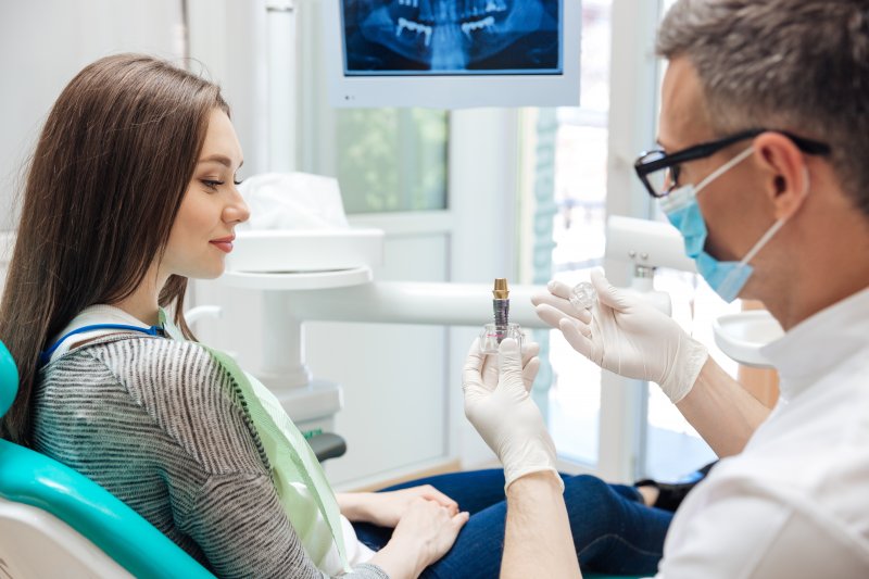 dentist explaining dental implant to patient