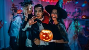 Family smiling and celebrating Halloween.