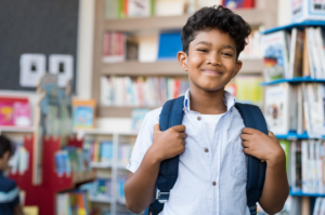 a young child smiling while at school