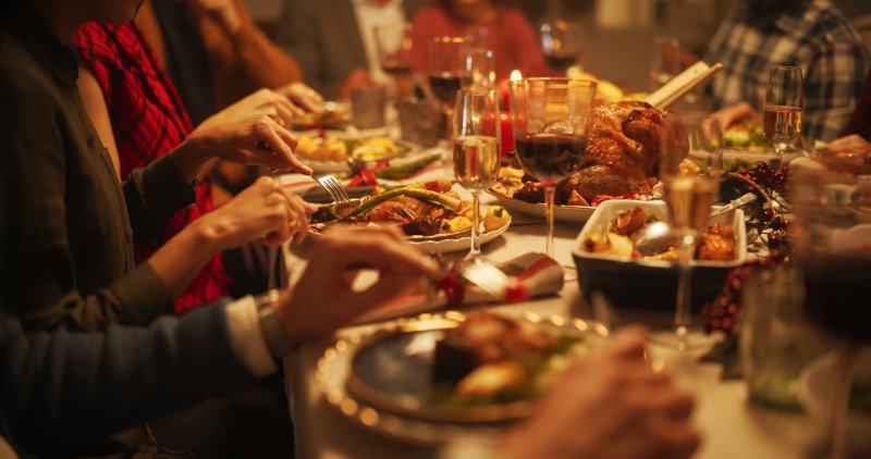 A family enjoying their holiday meal with good oral health