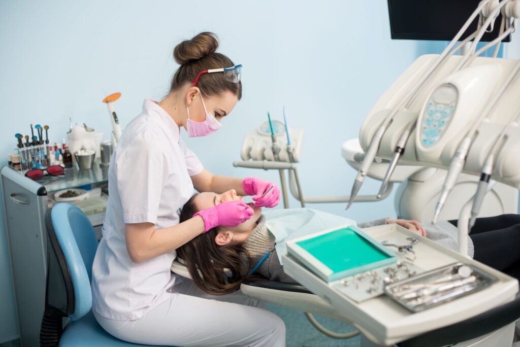 Dentist working on woman's teeth