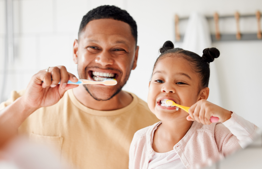 Dad and daughter brushing teeth