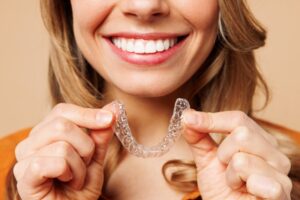 Woman putting in her Invisalign tray